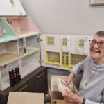 Patricia Shaw with her doll house