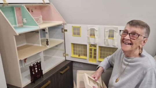 Patricia Shaw with her doll house