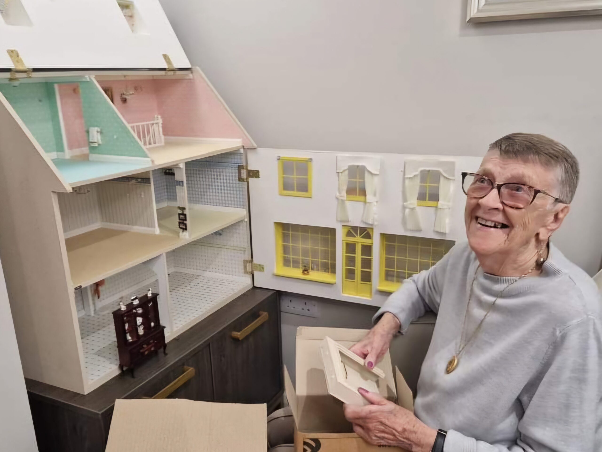 Patricia Shaw with her doll house