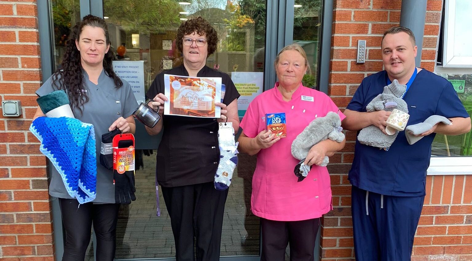 Alan and staff members with recent 'keep warm' essentials donations